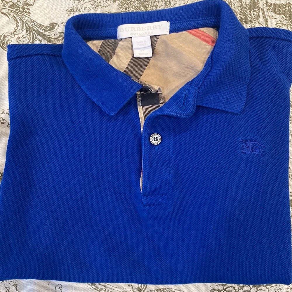 Children Blue Polo style Burberry shirt in a size 6.